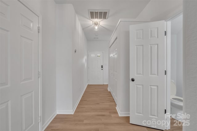 hall with light hardwood / wood-style floors