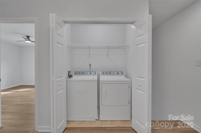 washroom featuring separate washer and dryer, ceiling fan, and light hardwood / wood-style flooring