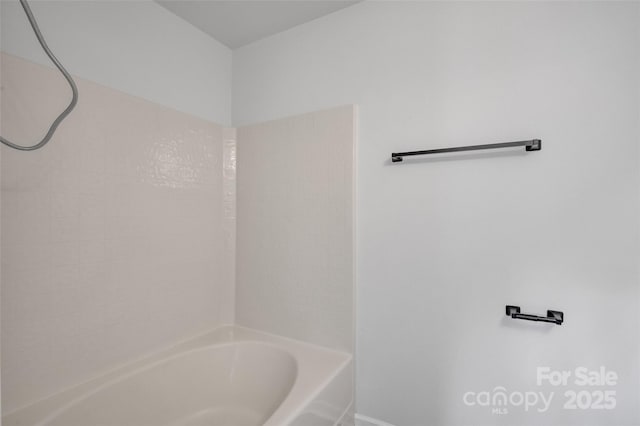 bathroom with bathing tub / shower combination