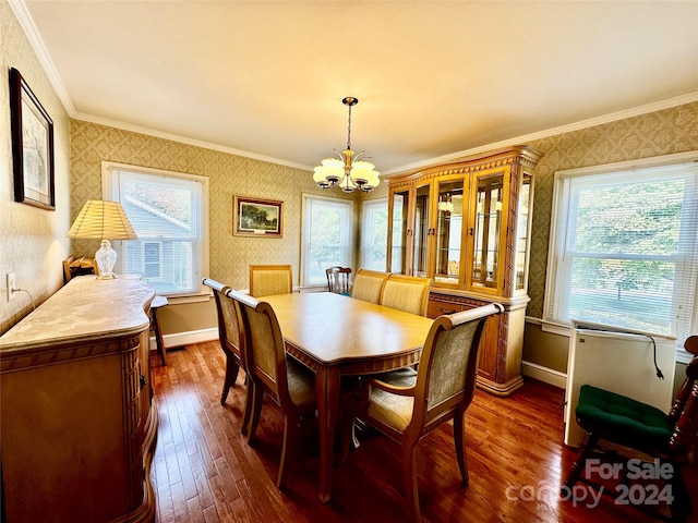 dining area with a notable chandelier, ornamental molding, dark hardwood / wood-style floors, and plenty of natural light