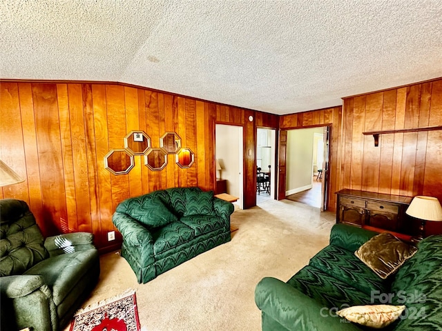 living room featuring light carpet, a textured ceiling, and wood walls