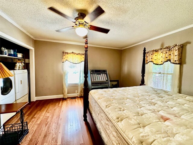 unfurnished bedroom with wood-type flooring, ceiling fan, independent washer and dryer, and crown molding