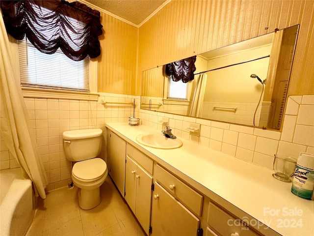 full bathroom featuring a wealth of natural light, a textured ceiling, vanity, and toilet