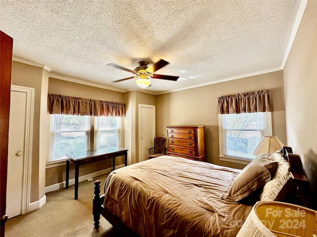 carpeted bedroom featuring multiple windows, a textured ceiling, and ceiling fan