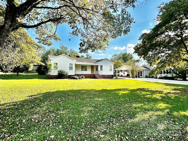 ranch-style home with a front lawn and covered porch