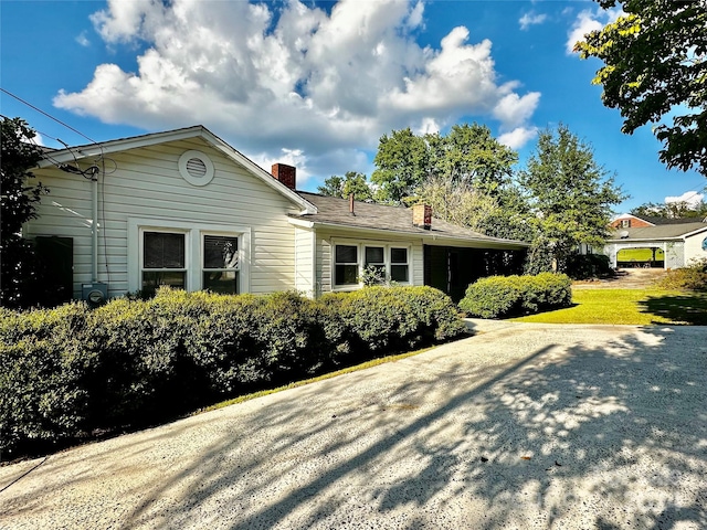 view of side of property with a lawn