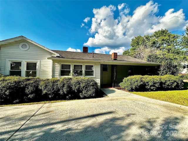 ranch-style house featuring a carport