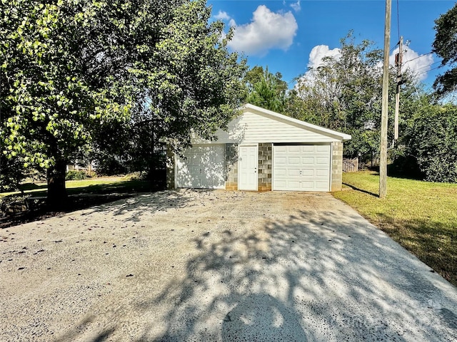 view of side of property featuring a lawn, an outdoor structure, and a garage