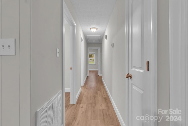 hallway with light wood-type flooring