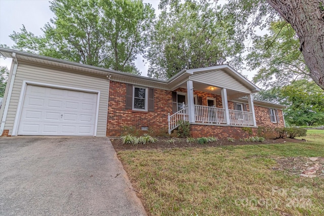 ranch-style house with a front lawn, a garage, and covered porch