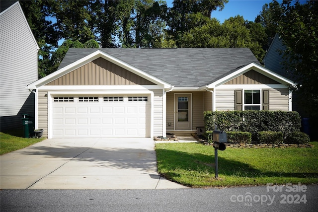 view of front of house with a garage and a front yard