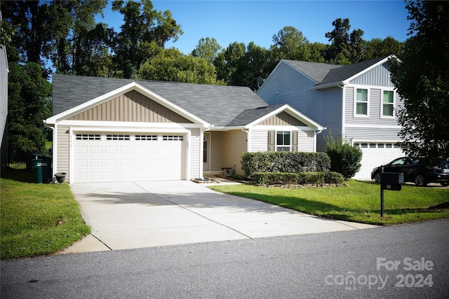 view of front of property featuring a garage and a front lawn