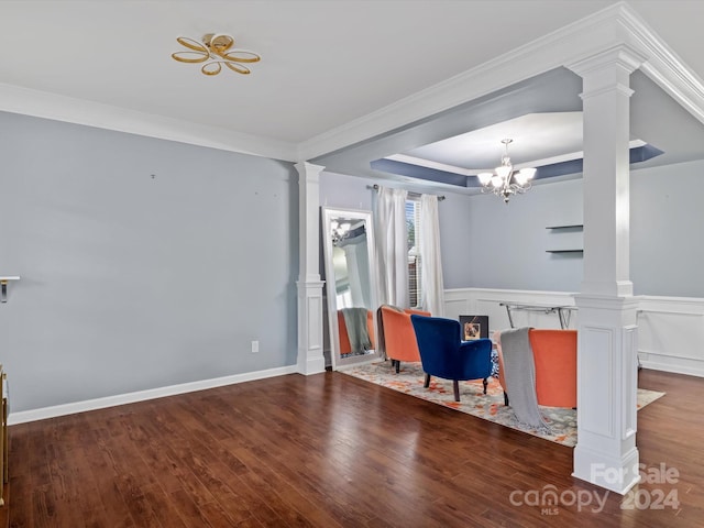 living area featuring ornamental molding, hardwood / wood-style floors, and a chandelier