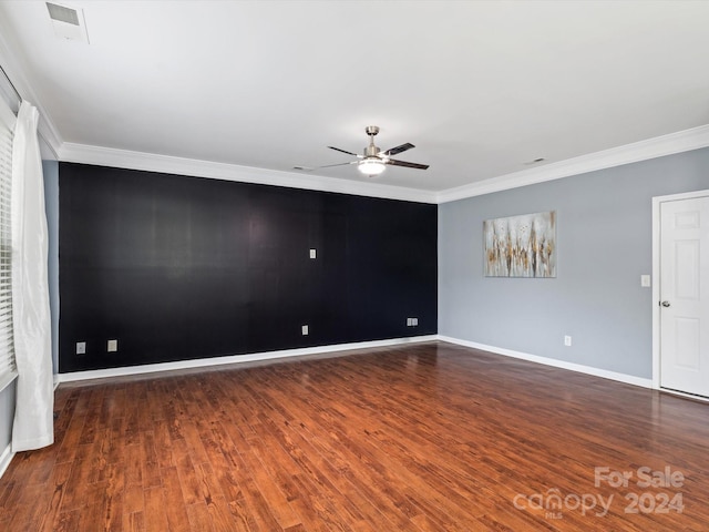 spare room featuring ornamental molding, ceiling fan, and dark wood-type flooring