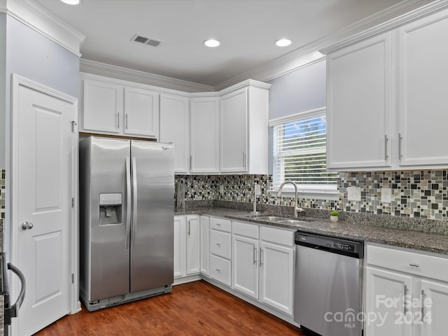 kitchen featuring stainless steel appliances, white cabinets, and dark hardwood / wood-style flooring