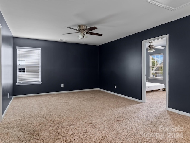 unfurnished room featuring carpet and ceiling fan