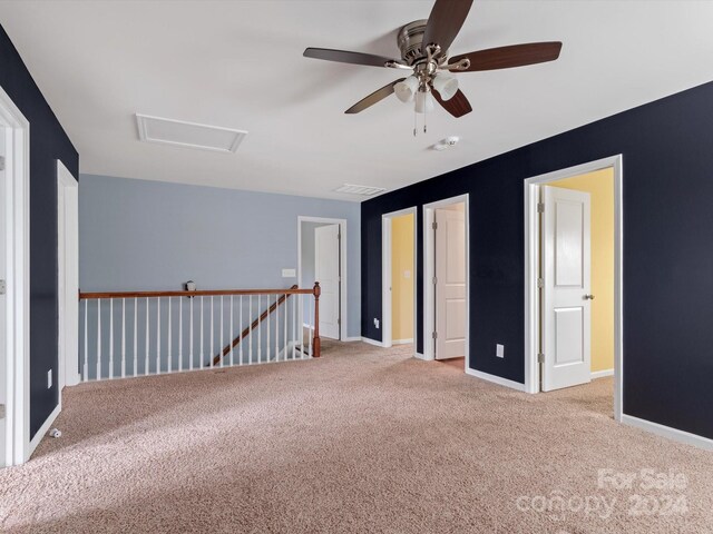 spare room with ceiling fan and light colored carpet