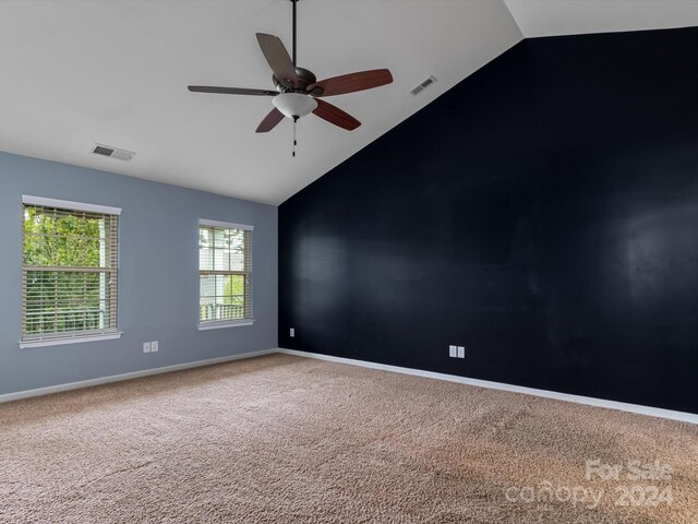 carpeted empty room featuring ceiling fan and high vaulted ceiling