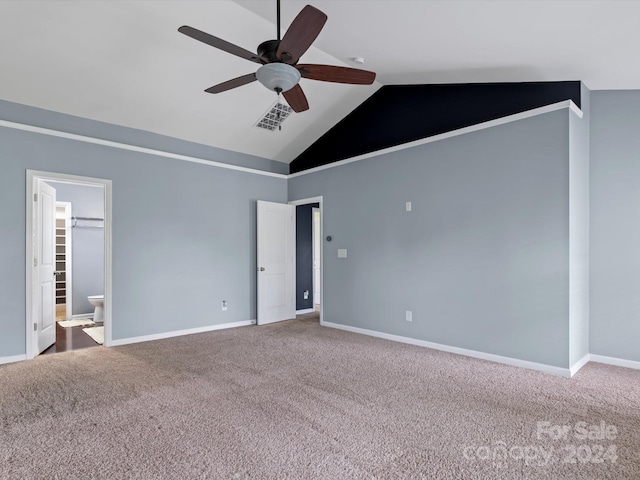 unfurnished bedroom featuring vaulted ceiling, ceiling fan, carpet floors, and ensuite bath