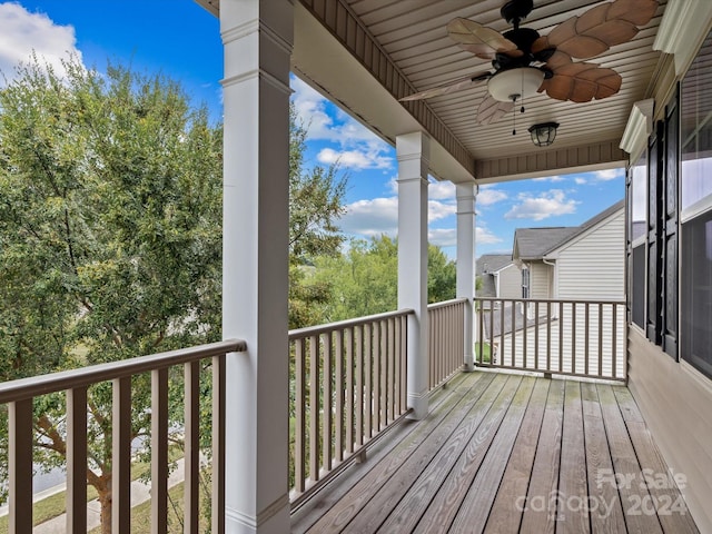 wooden deck featuring ceiling fan