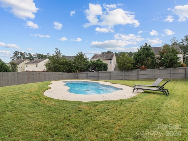 view of pool with a yard