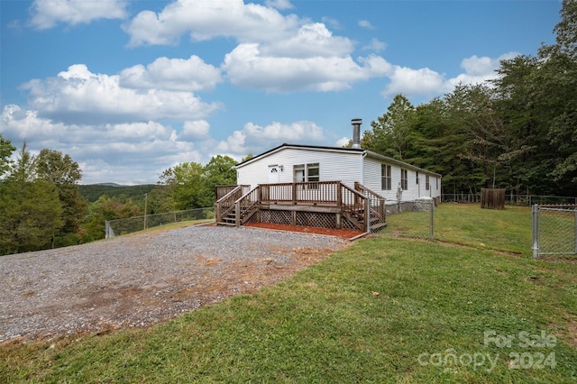 exterior space featuring a lawn and a deck