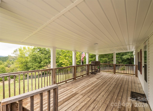 wooden terrace featuring a yard