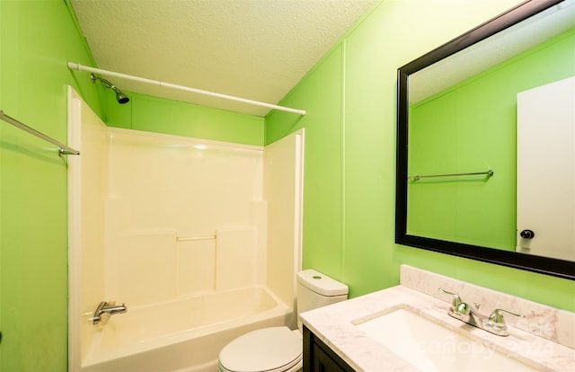 full bathroom featuring a textured ceiling, vanity, toilet, and bathtub / shower combination