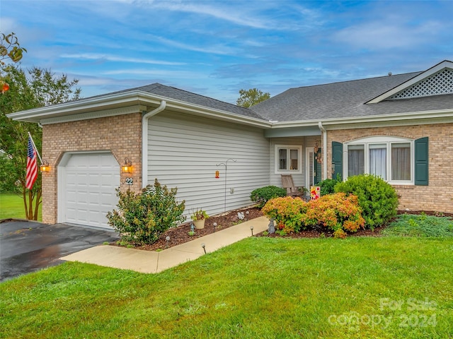 exterior space featuring a lawn and a garage