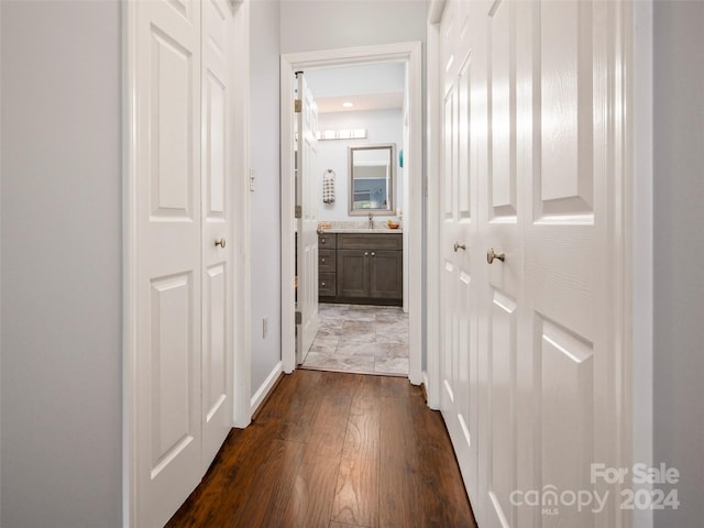 corridor with dark hardwood / wood-style flooring