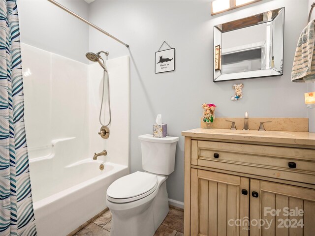 full bathroom with shower / bath combination with curtain, tile patterned flooring, vanity, and toilet