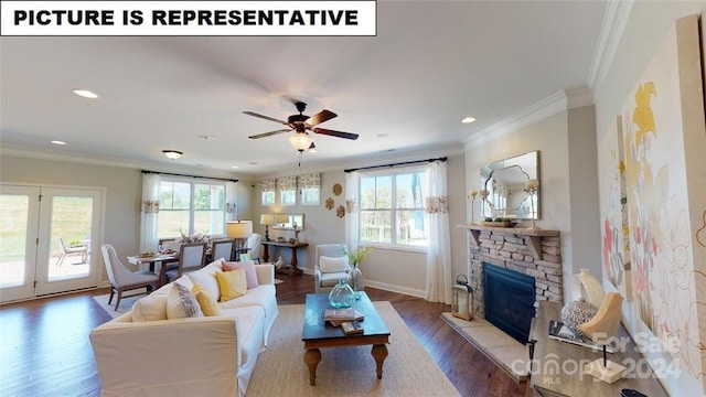 living room featuring wood-type flooring, a stone fireplace, ceiling fan, and crown molding