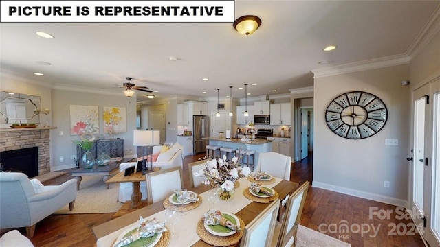 dining room featuring a stone fireplace, ceiling fan, dark hardwood / wood-style floors, and ornamental molding