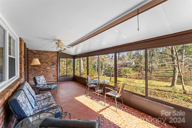 sunroom featuring plenty of natural light, ceiling fan, and vaulted ceiling