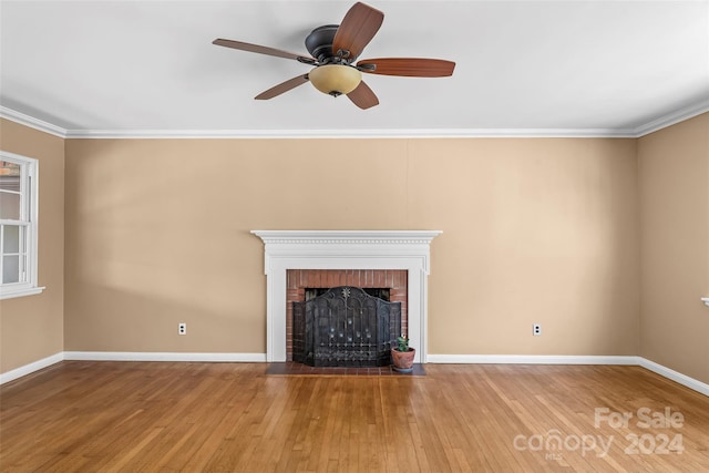 unfurnished living room featuring a brick fireplace, ceiling fan, crown molding, and light hardwood / wood-style flooring