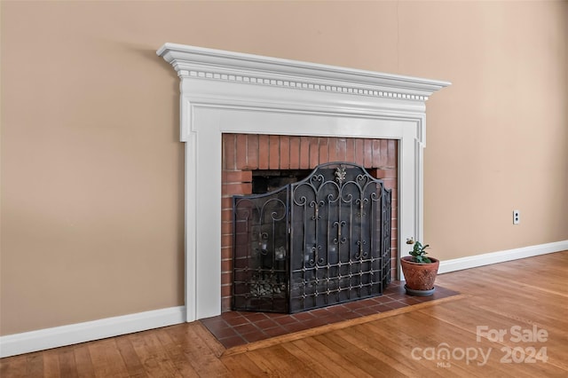 details with hardwood / wood-style flooring and a fireplace