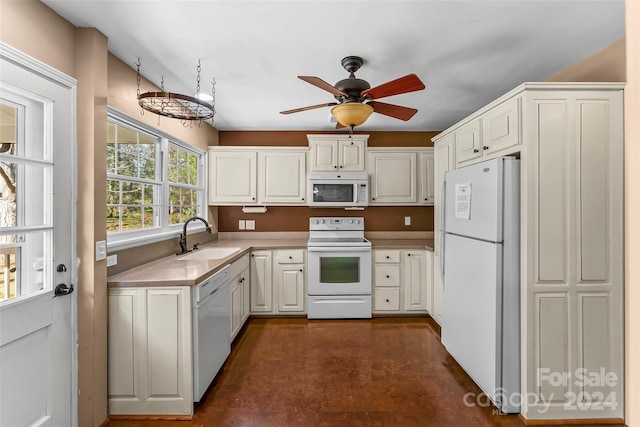 kitchen featuring white appliances, white cabinetry, ceiling fan, and sink