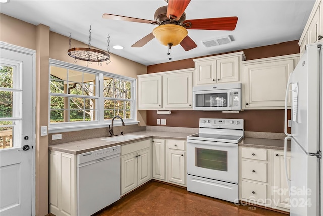 kitchen featuring ceiling fan, white appliances, sink, and a wealth of natural light