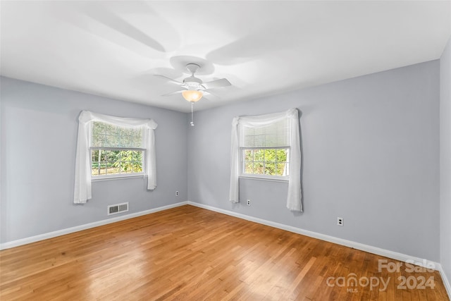 unfurnished room with ceiling fan and light wood-type flooring