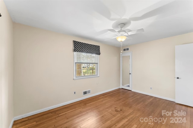 spare room with hardwood / wood-style floors and ceiling fan