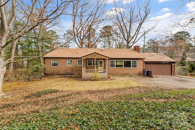 ranch-style house featuring a porch and a garage