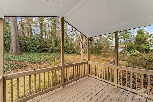 unfurnished sunroom with vaulted ceiling with beams and plenty of natural light