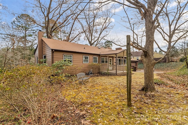 rear view of property featuring a deck