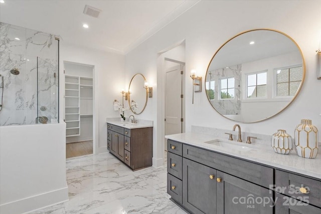 bathroom featuring ornamental molding, vanity, and a shower