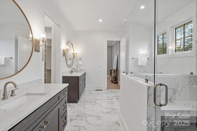 bathroom featuring vanity and a shower with door