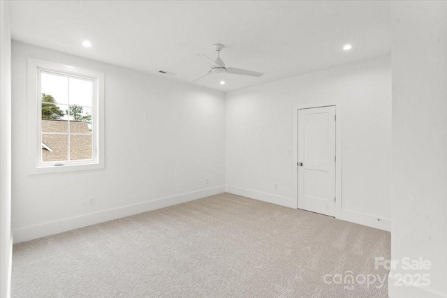 unfurnished room featuring light colored carpet and ceiling fan