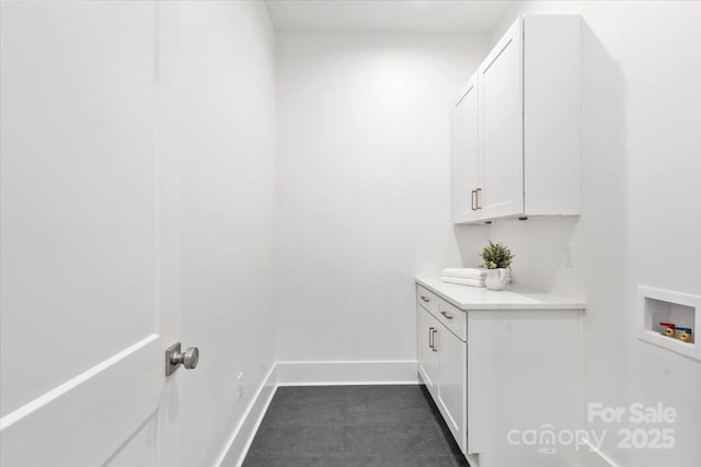 clothes washing area featuring cabinets and washer hookup