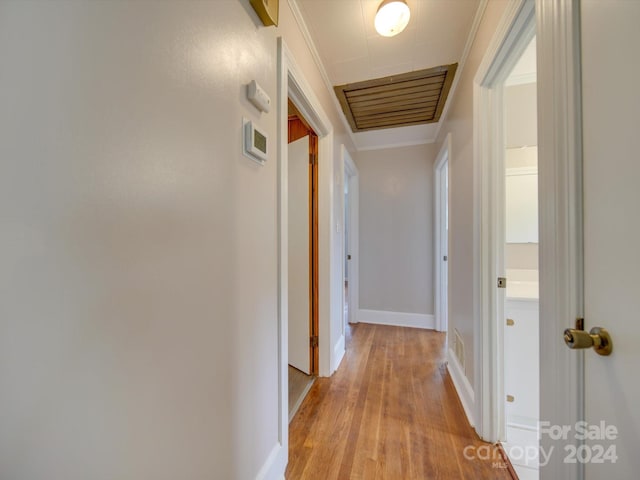 hall featuring light hardwood / wood-style floors and ornamental molding