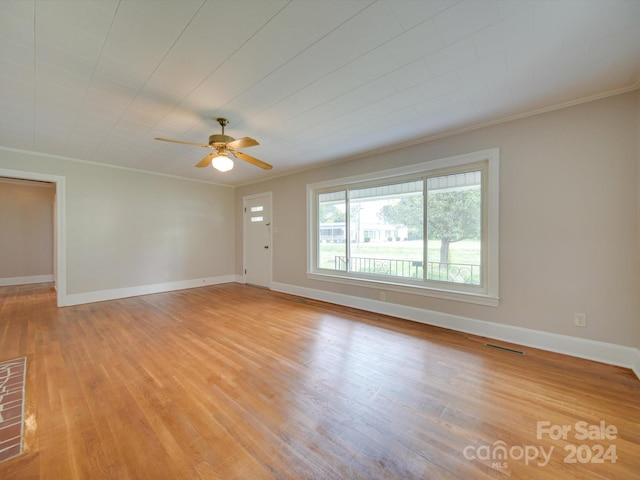 spare room with light hardwood / wood-style floors, ceiling fan, and crown molding