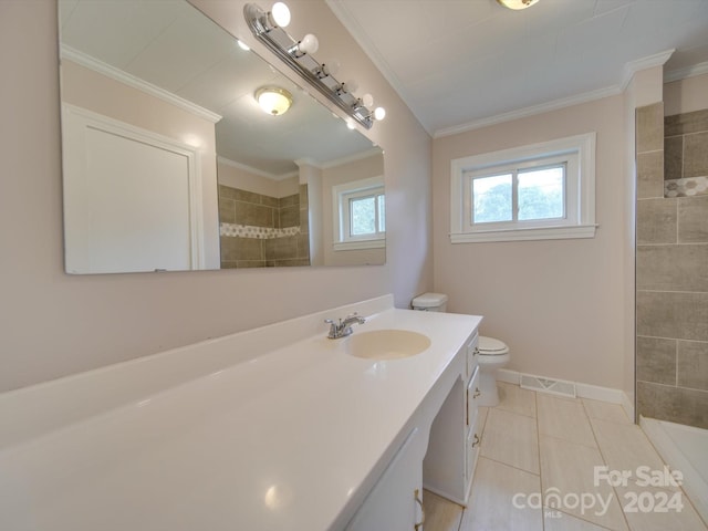 bathroom featuring tile patterned floors, crown molding, vanity, and toilet